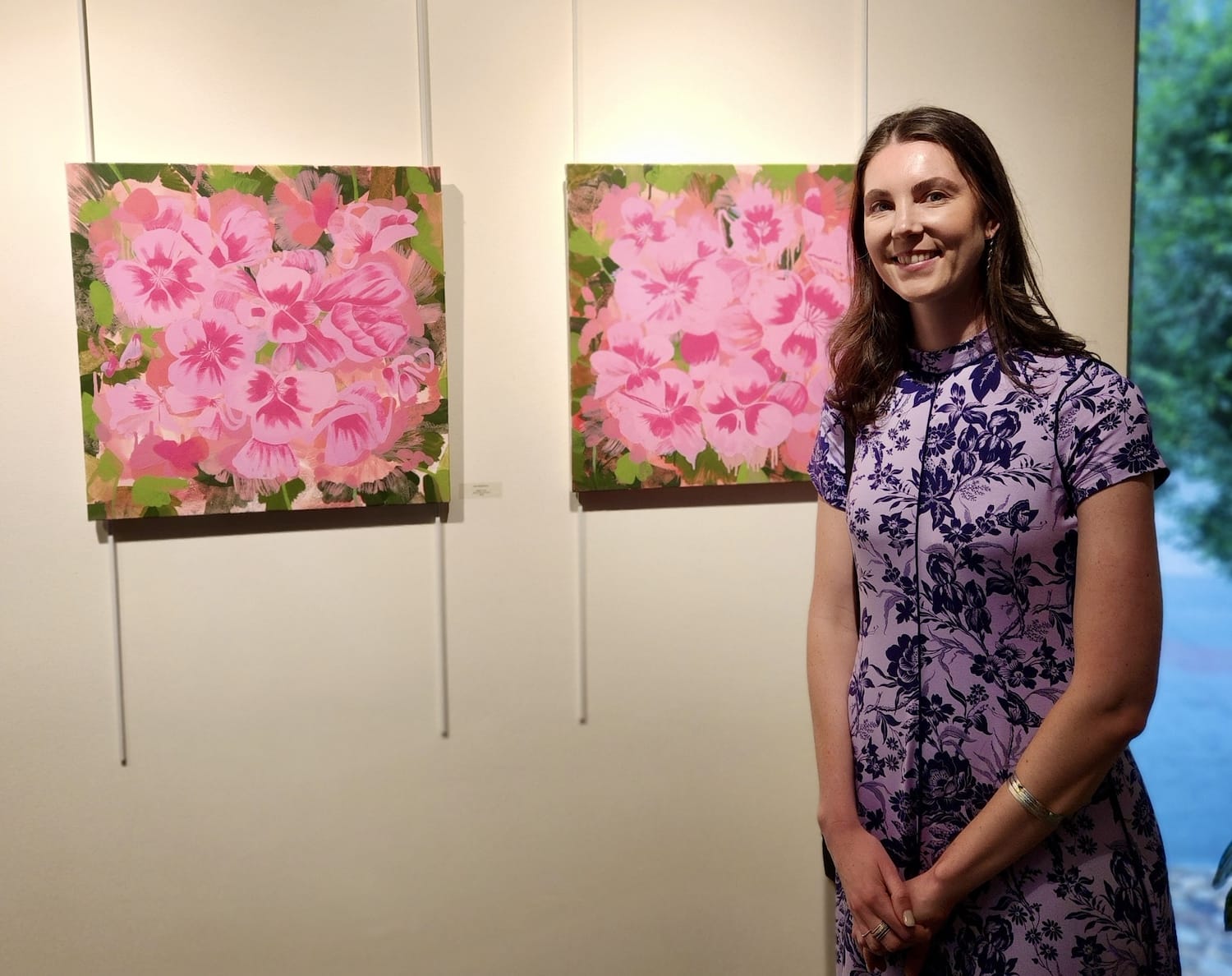 woman next to painting